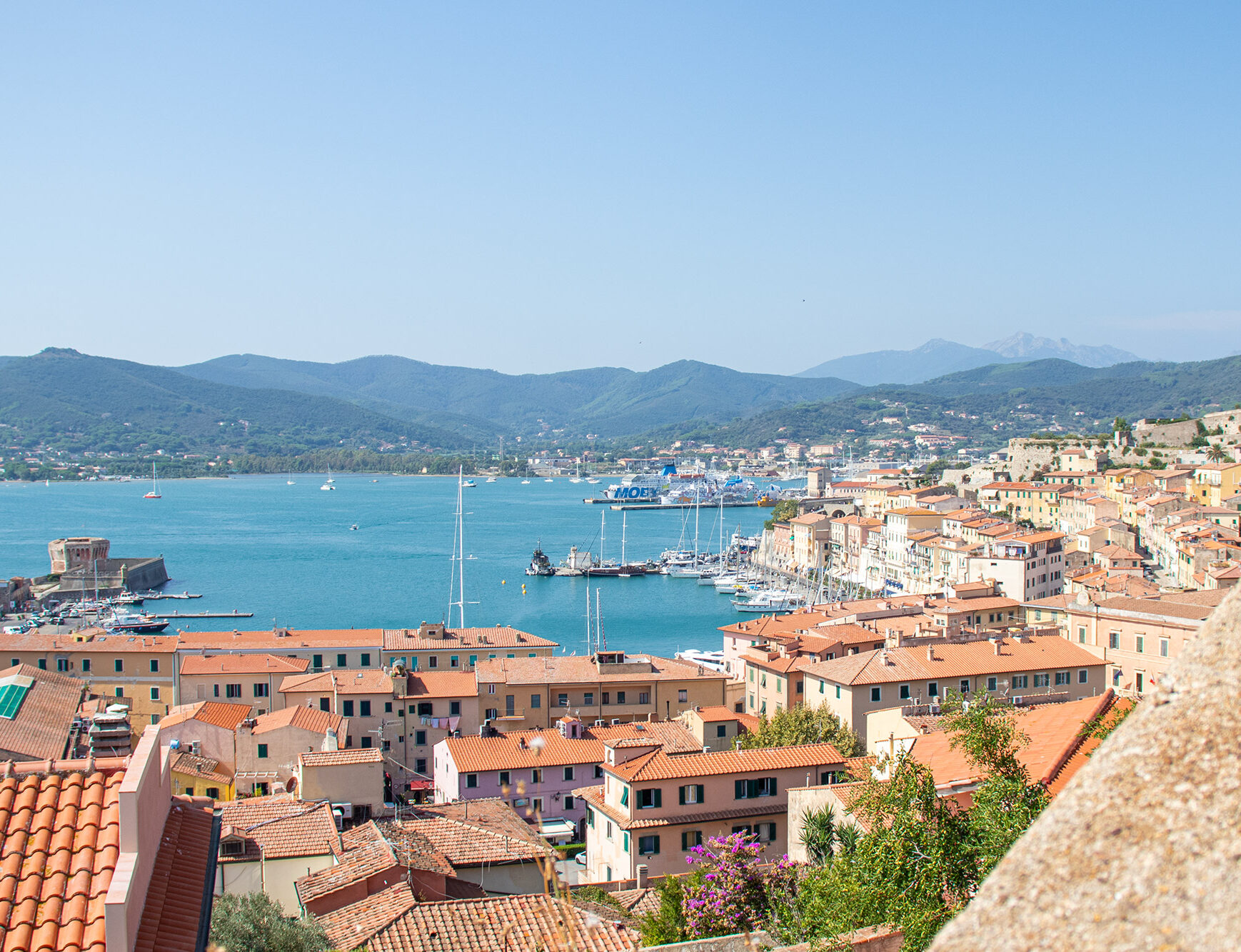 Aerial view in island Elba of houses and Mediterranean Sea.